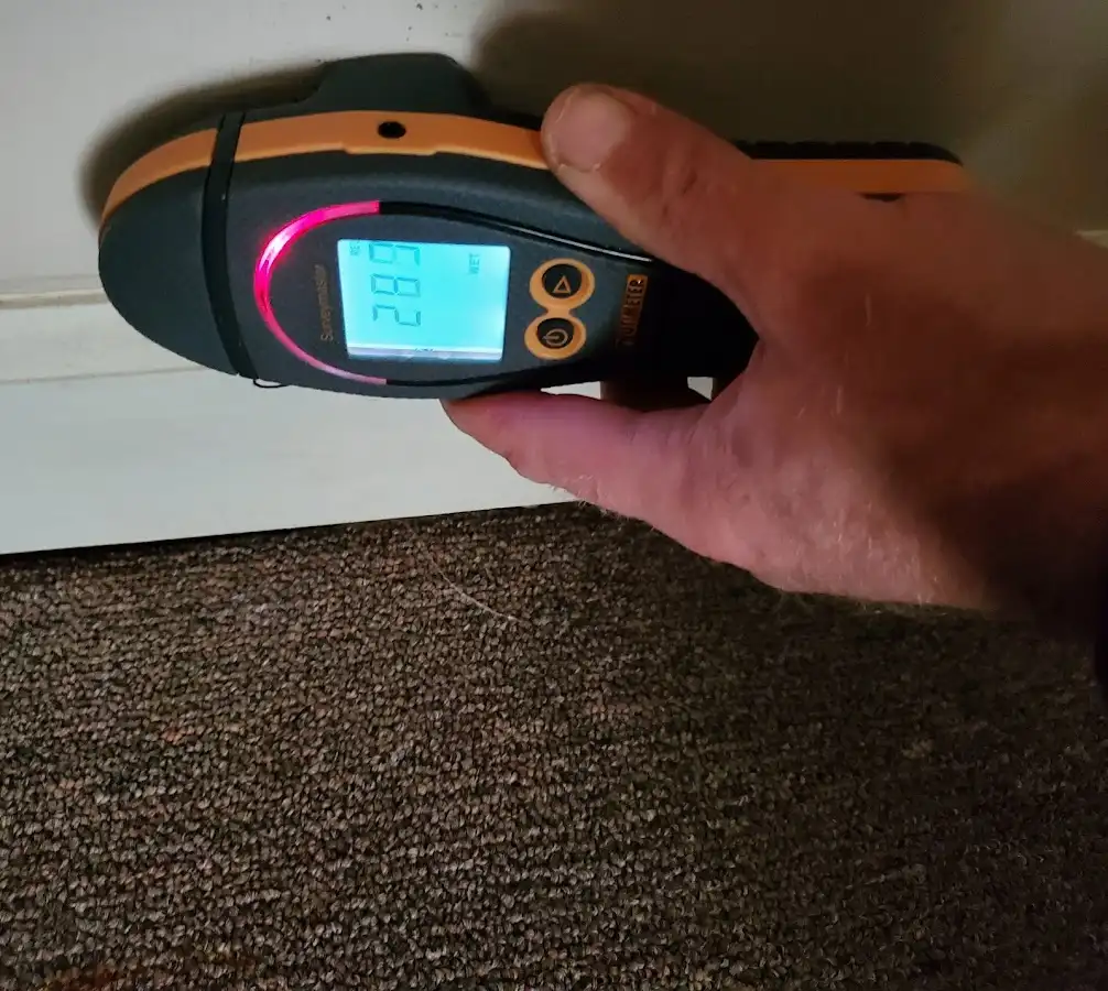 Moisture detection at baseboard during Storm Damage Restoration in Mount Healthy